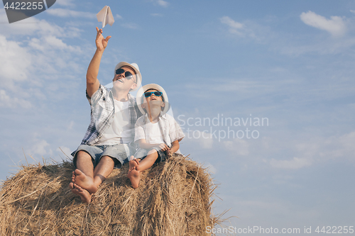 Image of Father and son playing in the park at the day time.