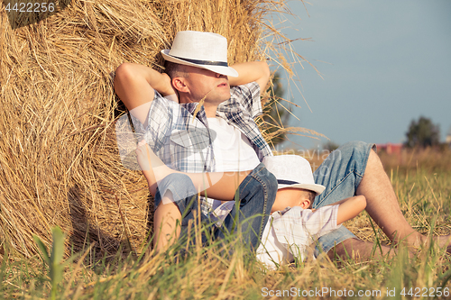 Image of Father and son playing in the park at the day time.