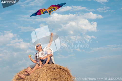 Image of Father and son playing in the park at the day time.