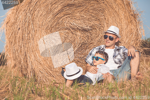 Image of Father and son playing in the park at the day time.