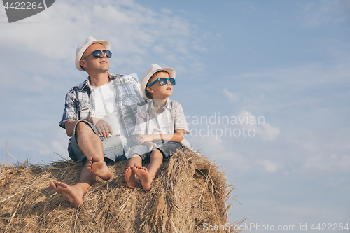 Image of Father and son playing in the park at the day time.