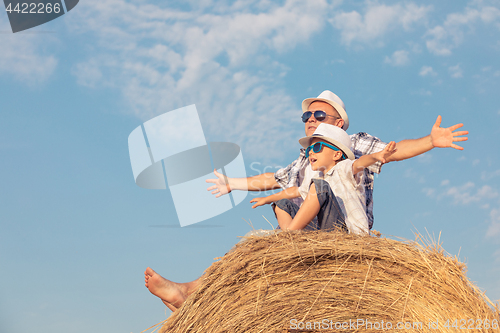 Image of Father and son playing in the park at the day time.