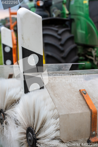 Image of Tractor cleaning reflector posts