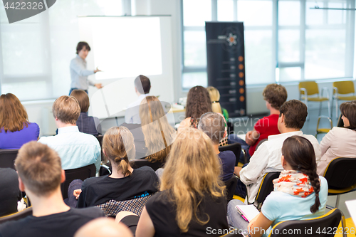 Image of Speaker giving presentation on business conference.