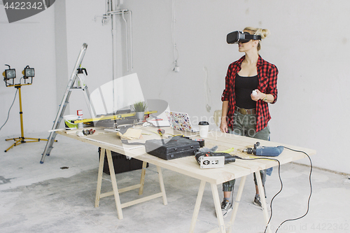 Image of Woman using virtual reality goggles in workshop 