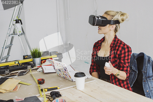 Image of Female in virtual reality headset at laptop 
