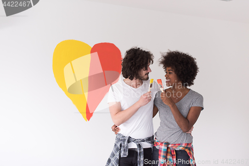 Image of couple with painted heart on wall