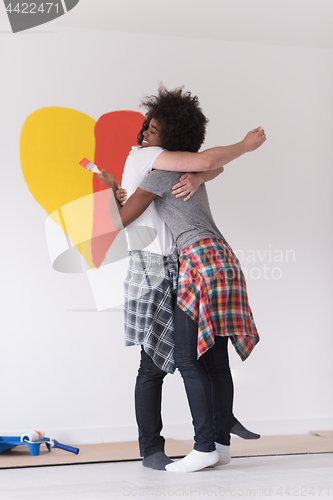 Image of couple with painted heart on wall