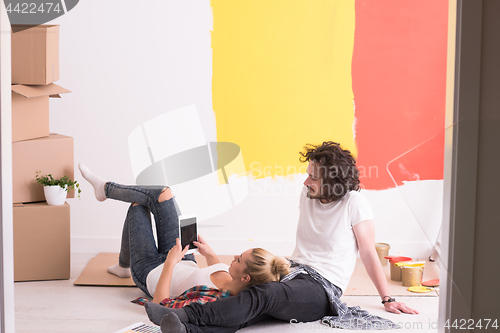 Image of Happy young couple relaxing after painting