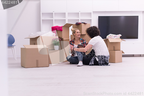 Image of young couple moving  in new house