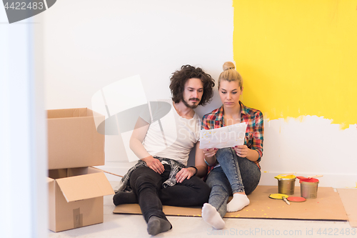 Image of Happy young couple relaxing after painting