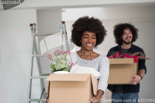 Image of multiethnic couple moving into a new home