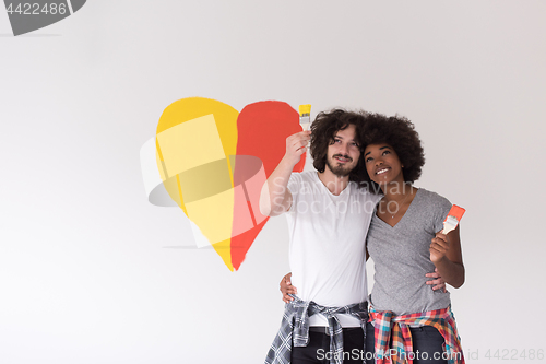 Image of couple with painted heart on wall