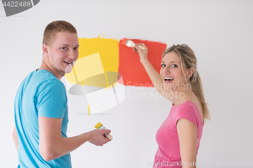 Image of couple painting interior wall