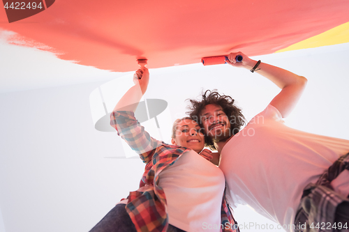 Image of couple painting interior wall