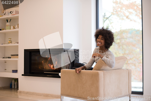 Image of black woman in front of fireplace