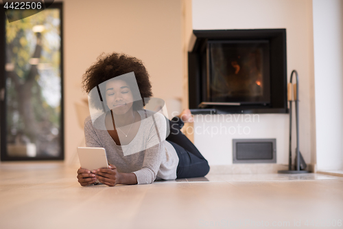 Image of black women using tablet computer on the floor