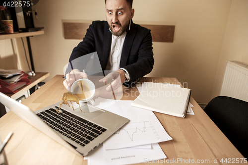 Image of Coffee in white cup spilling on the table in the morning working day at office table