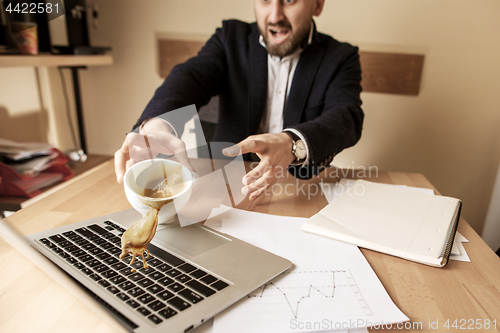 Image of Coffee in white cup spilling on the table in the morning working day at office table
