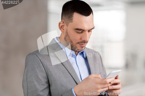 Image of businessman with smarphone at office