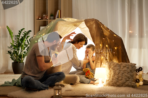 Image of father telling scary stories to his daughter