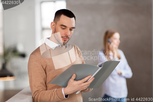 Image of male office worker with folder