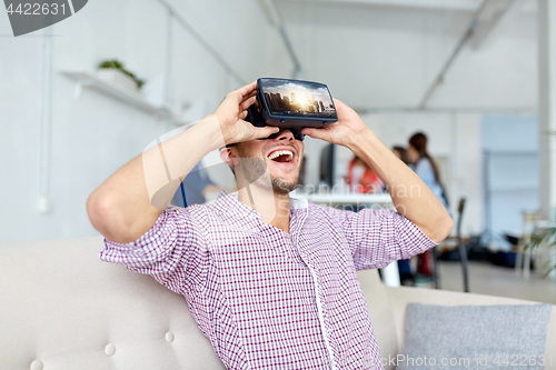 Image of happy man with virtual reality headset at office