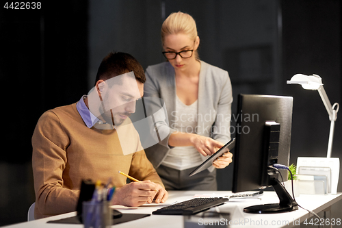Image of business team with tablet pc work at night office