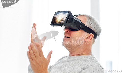 Image of old man in virtual reality headset or 3d glasses