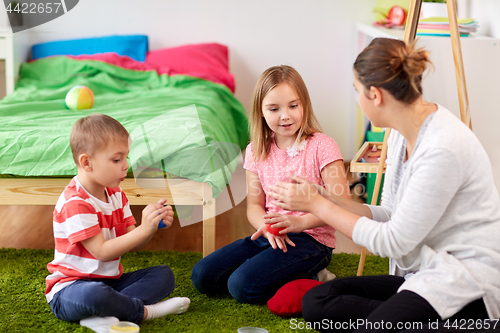 Image of kids and mother with modelling clay or slimes