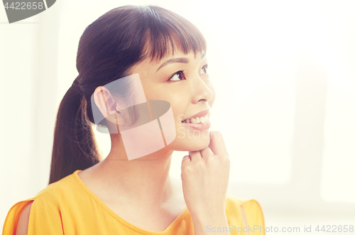 Image of happy asian young dreaming woman face at home