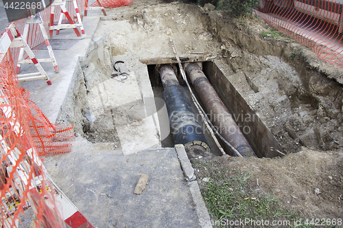 Image of Repair of heating pipes at a depth of excavated trench