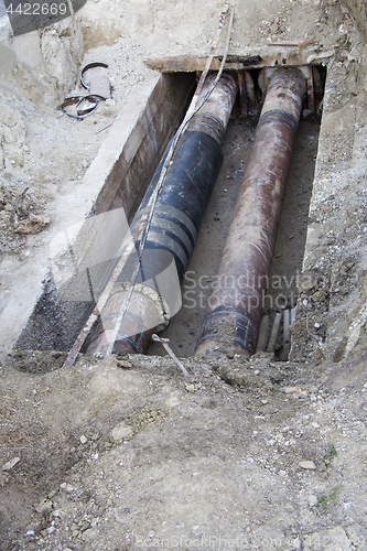 Image of Repair of heating pipes at a depth of excavated trench