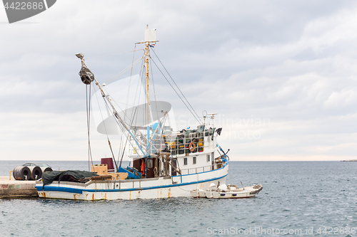 Image of Fishing boat mooring at the pier in mediterranean sea.