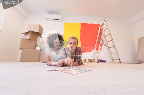 Image of Happy young couple relaxing after painting