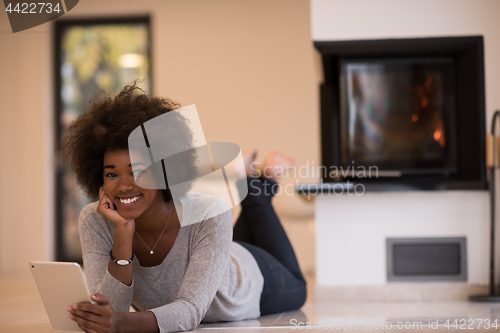 Image of black women using tablet computer on the floor