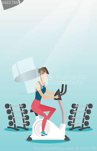 Image of Young woman riding stationary bicycle.