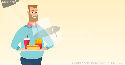 Image of Man holding tray full of fast food.