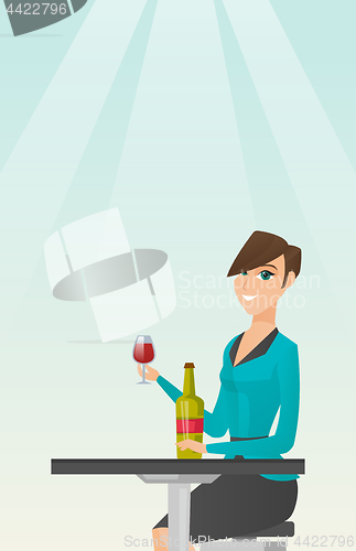 Image of Woman drinking wine in the restaurant.