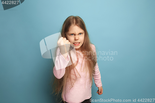 Image of The threat. Teen girl on a blue background. Facial expressions and people emotions concept