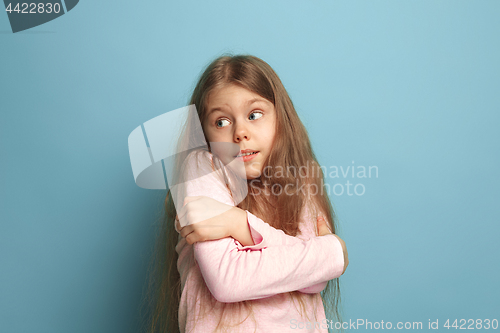 Image of The surprise. Teen girl on a blue background. Facial expressions and people emotions concept