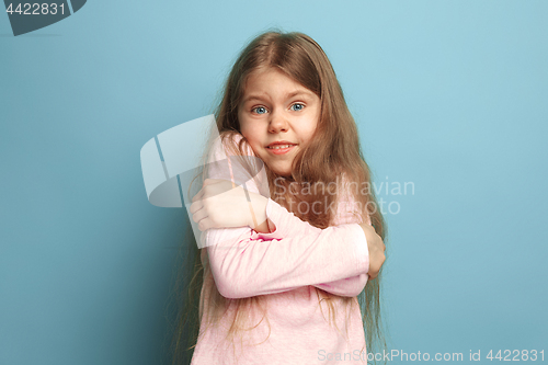 Image of The surprise. Teen girl on a blue background. Facial expressions and people emotions concept