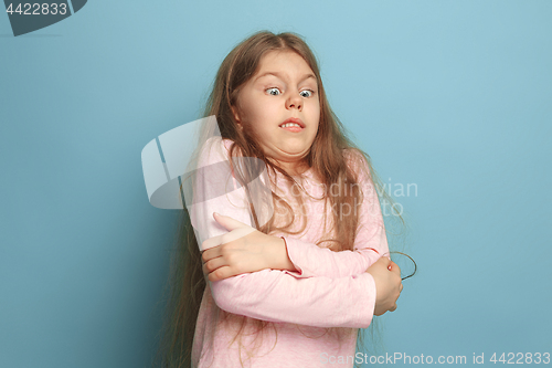 Image of The surprise. Teen girl on a blue background. Facial expressions and people emotions concept