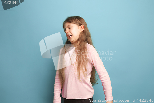 Image of The disgust. Teen girl on a blue background. Facial expressions and people emotions concept