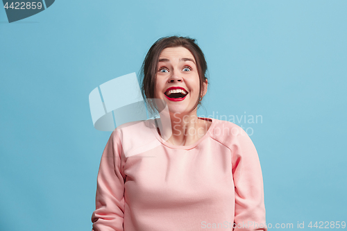Image of Beautiful woman looking suprised isolated on blue