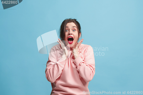 Image of Beautiful woman looking suprised isolated on blue