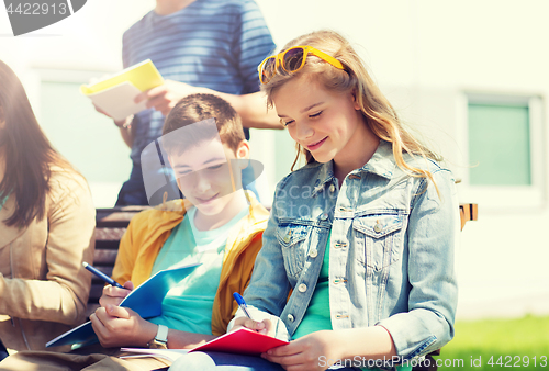 Image of group of students with notebooks at school yard