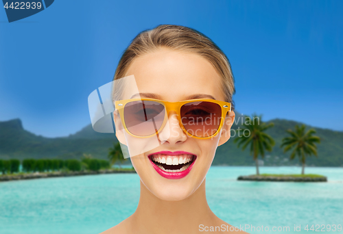 Image of woman in sunglasses over bora bora beach