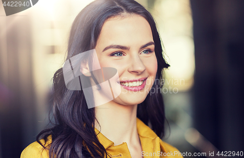 Image of smiling young woman in city