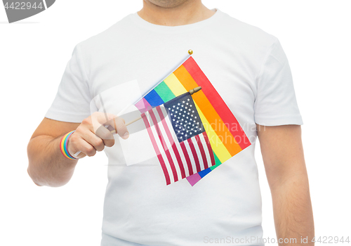 Image of man with gay pride rainbow flag and wristband